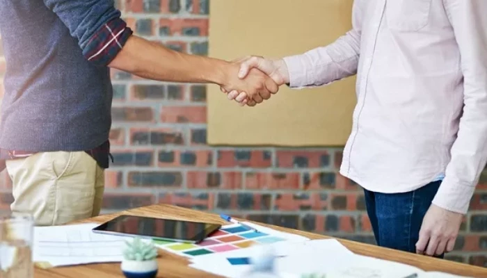 Two men shaking hands in an office