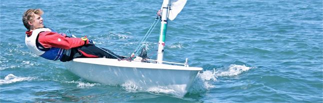 young boy learning to sail a dinghy