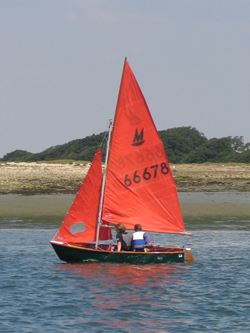 couple in a dinghy close to shore